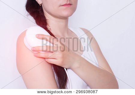 The Girl Treats A Sore Shoulder Joint With The Help Of Physiotherapy Magnet, Pain Relief And Inflamm