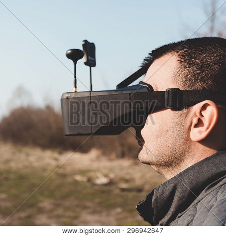 Fpv Drone Pilot In A Virtual Reality Helmet With A Remote Control From A Copter Flies In Aircraft Ou