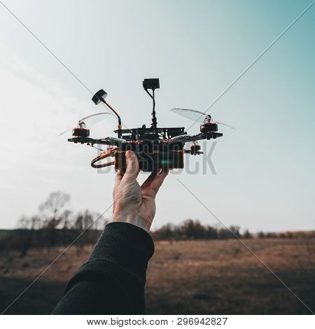 Pilot Racing Drone Holds In His Hand Fpv Copter Before Launching It. A Small High-speed Aircraft Wit