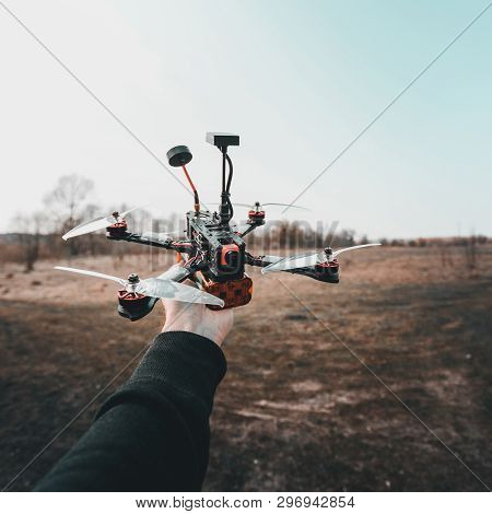 Pilot Racing Drone Holds In His Hand Fpv Copter Before Launching It. A Small High-speed Aircraft Wit