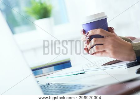 Morning Coffee Before A Productive Working Day. Young Female Office Worker Holding Coffee Papercup A