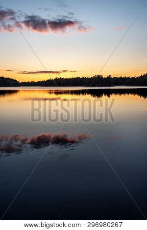 Beautiful And Colorful Sunset Over Forest Lake