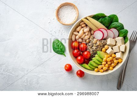 Healthy Vegan Buddha Bowl With Spinach, Tomato, Chickpea, Quinoa, Radish, Beans, Avocado, Mini Corn