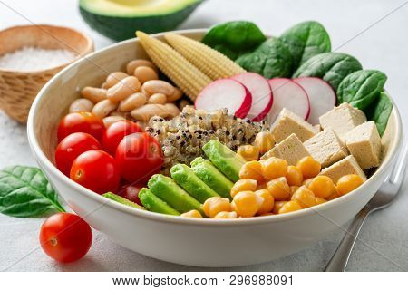 Healthy Vegan Buddha Bowl With Spinach, Tomato, Chickpea, Quinoa, Radish, Beans, Avocado, Mini Corn