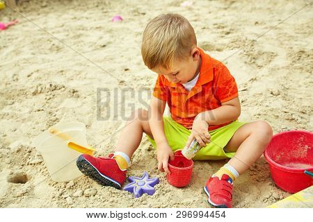 Little Boy On Playground. Playing Child In Sandbox