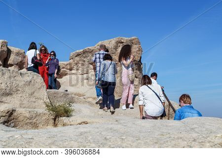 Uchisar, Turkey - October 4, 2020: Unidentified People Climb A Top Of The Tuff Rock (uchisar Castle)