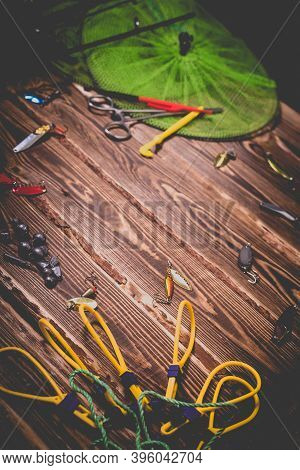 Fishing Tackle On A Wooden Background. Studio Photo With Vignetting.