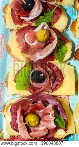 Bread With Prosciutto Isolated On White Background. Sandwiches Close Up, Italian Antipasta.