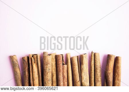 Cinnamon Sticks On The Pink Background With Copy Space For Your Text
