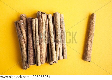 Cinnamon Sticks On The Yellow Background With Copy Space For Your Text