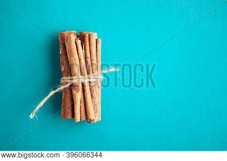 Cinnamon Sticks Held Together With Jute Rope On Turquois Background
