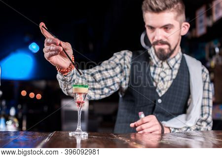 Professional Barman Demonstrates His Skills Over The Counter At Bar