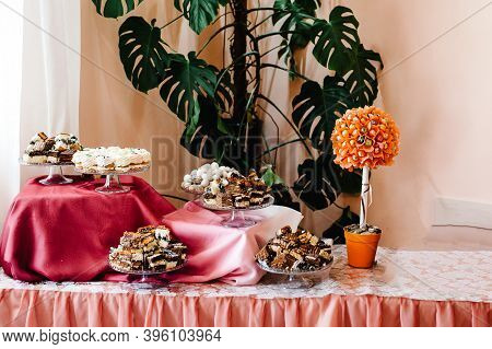 Table With Muffins, Cakes, Sweets, Candy, Buffet. Dessert Table For A Party Goodies For The Wedding 