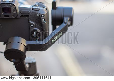 Ronin Stabilizer And Camera Overlooking A Blurry Street