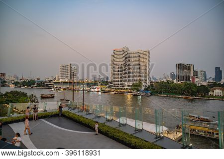 Bangkok/thailand-29 Dec 2019:unacquainted People Walking On The Park With Beautiful Cityscape And Ri
