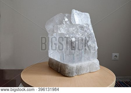 Monocrystalline Table Salt Lamp On A Wooden Stand.