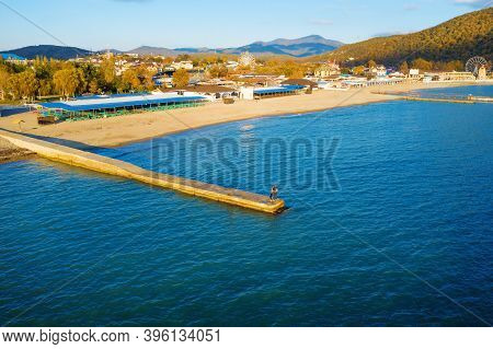 Silhouette Of Couple Standing At End Of Concrete Pier, Aerial View. Romantic Atmosphere At Autumn Em