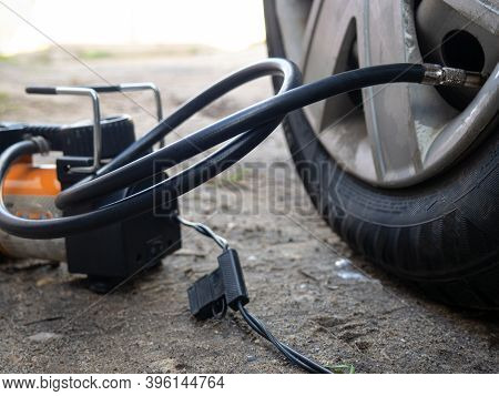 Pump Up The Autowheel Compressor On The Road. Car Electro Pump.