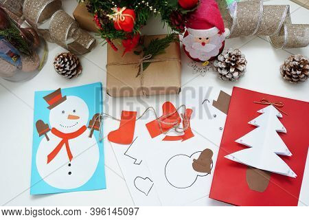Christmas Handcraft Greeting Cards With Dedcorations On White Table