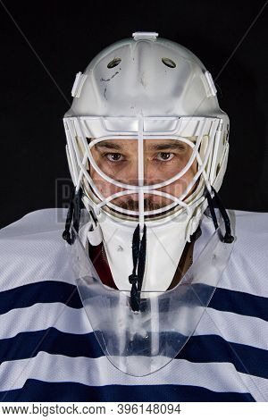 Detail Of A Male Face In A White Goalie Hockey Mask And  Colorful Lights.this Is A Detail Hockey Goa