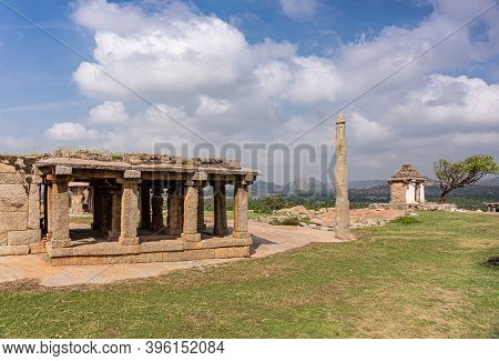 Hampi, Karnataka, India - November 4, 2013: Ruins At Moola Virupaksha Temple Behind Green Lawn And U