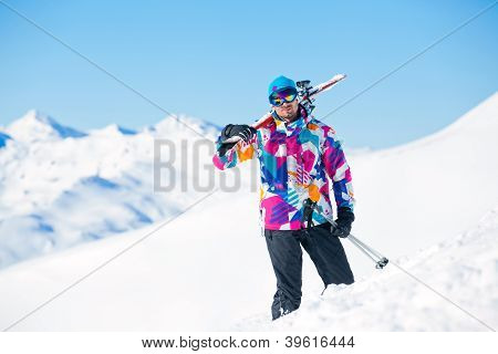 Young man with skis and a ski wear