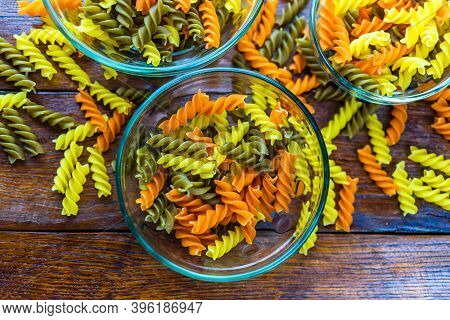 Composition Of Raw Pasta Uncooked Tricolore Fusilli, Pasta Twist Shape. Close Up And Selective Focus