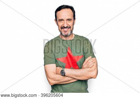 Middle age handsome man wearing t-shirt with revolutionary red star over white background happy face smiling with crossed arms looking at the camera. Positive person.