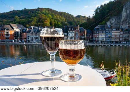 Drinking Of Dark And Strong Belgian Abbey Beer With Cheeses With Nice View On Maas River And Town Di