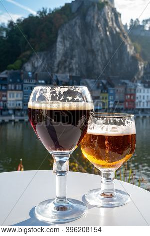 Drinking Of Dark And Strong Belgian Abbey Beer With Cheeses With Nice View On Maas River And Town Di