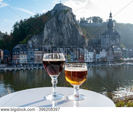 Drinking Of Dark And Strong Belgian Abbey Beer With Cheeses With Nice View On Maas River And Town Di