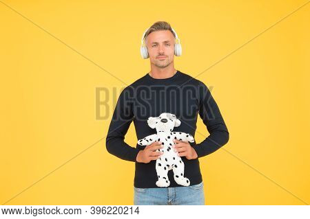 Childish And Infantile. Childish Adult Hold Toy Dog Yellow Background. Imaginative Friend. Pretend P