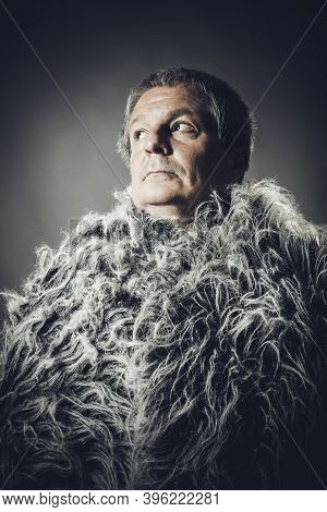 Solid Middle-aged Man In A Fur Mantle