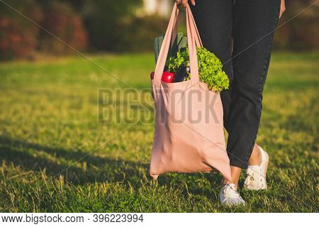 Young Woman Holding Eco Reusable Textile Grocery Bag With Fresh Bio Vegetables. Plant Based Vegan Di