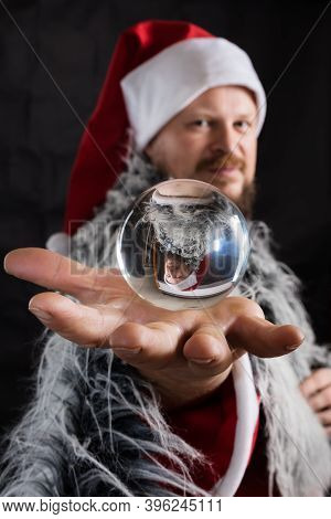 Cheerful Santa Dressed In Fur Skin With Crystal Spehre