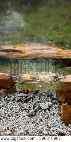 Pieces Of Fried Chicken Baked On On An Open Fire