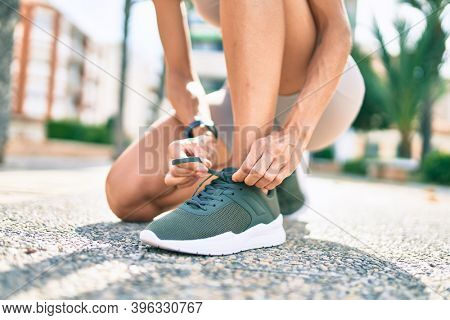 Close up of woman feet wearing training sneakers doing lace ready for running