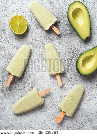 Homemade Raw Vegan Avocado Lime Popsicle. Sugar-free, Non-dairy Green Ice Cream On Gray Background. 