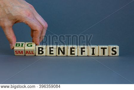 Time To Big Benefits. Male Hand Flips Wooden Cubes And Changes The Words 'small Benefits' To 'big Be