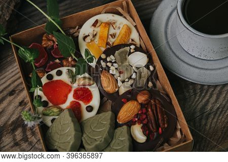 Chocolates With Dried Fruits In A Craft Box And A Cup Of Espresso Coffee.