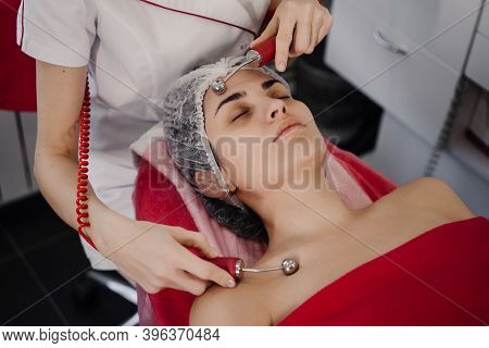 Woman Does Anti-aging Procedures With Cosmetologist. High Quality Photo