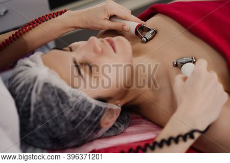 Woman Does Anti-aging Procedures With Cosmetologist. High Quality Photo