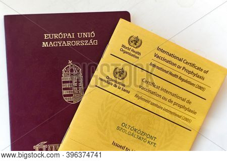 Bogota, Colombia - Circa 2019: Showing passport and vaccination certificate booklet issued by WHO listing vaccines given for traveling around the world, showing documents at immigration control