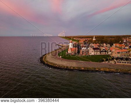 Urk Lighthouse With Old Harbor During Sunset, Urk Is A Small Village By The Lake Ijsselmeer In The N