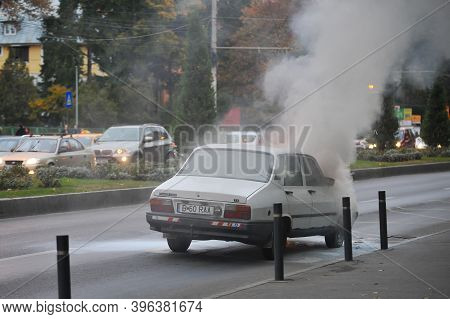 Bucharest, Romania - November 3, 2011: Old Dacia Car Caught Fire In The Middle Of The Street.