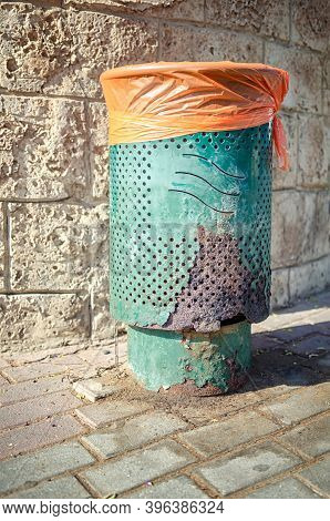 Green Street Trash Can Is Damaged By Dog Urine. It Is Rusty On The Lower Side Where Dogs Marked Thei