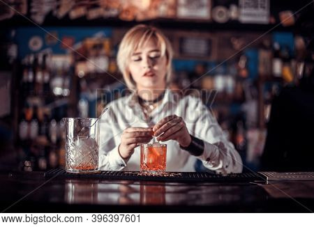 Portrait Of Woman Bartender Surprises With Its Skill Bar Visitors While Standing Near The Bar Counte