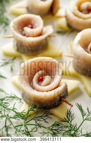 Close Up View Of Herring Fillets Rolled Up In A Spiral And Fastened With A Toothpick. Traditional Fe