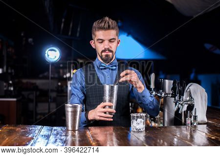 Barman Formulates A Cocktail At The Porterhouse
