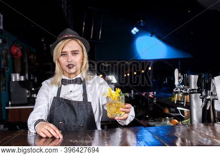 Professional Girl Bartender Places The Finishing Touches On A Drink Behind Bar